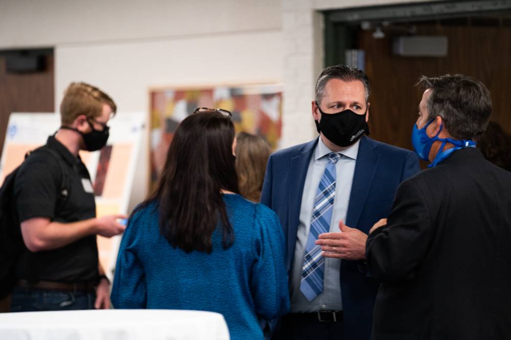 Administrators wearing masks talking about the event.